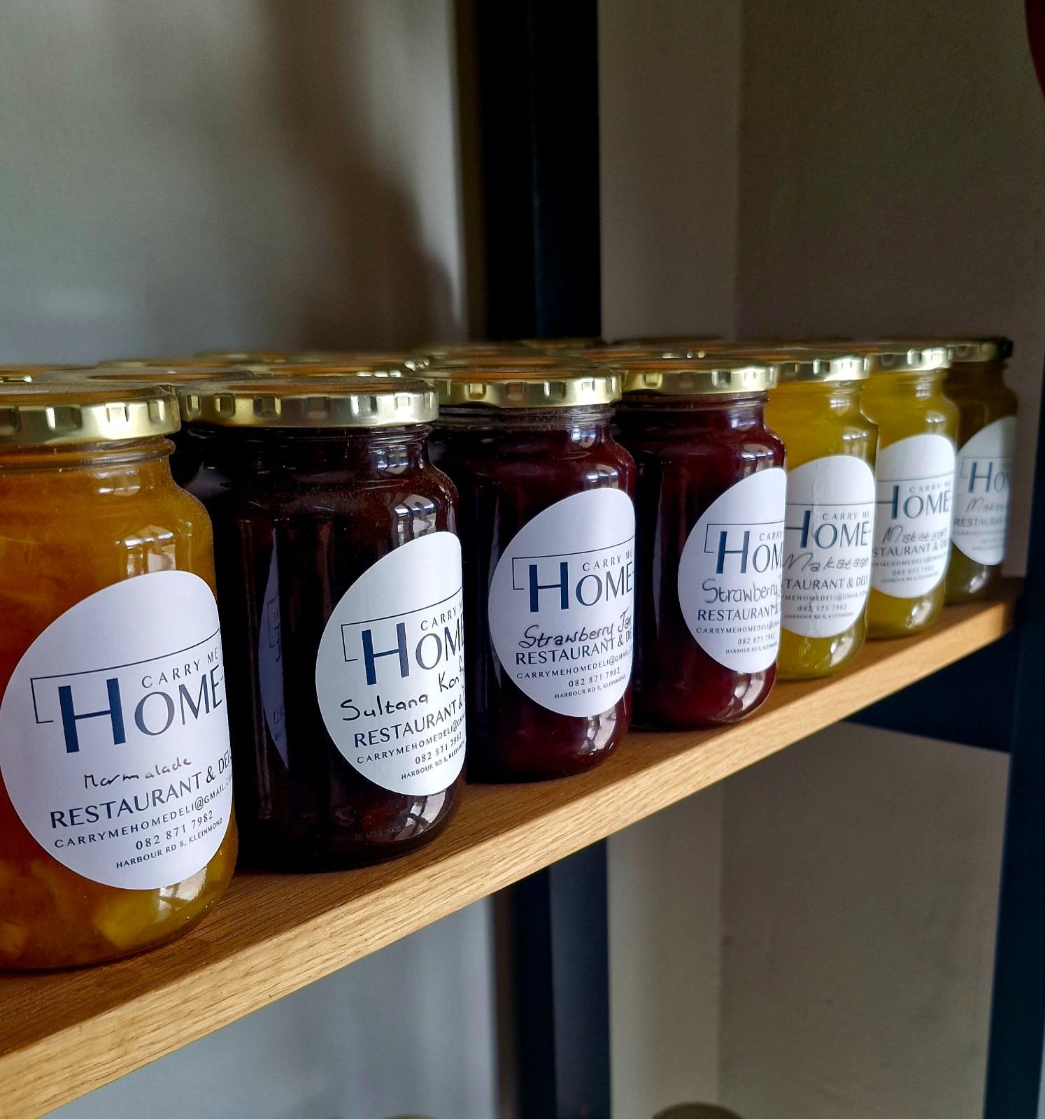 A shelf of Carry Me Home marmalade, sultana konfyt and strawberry jam
